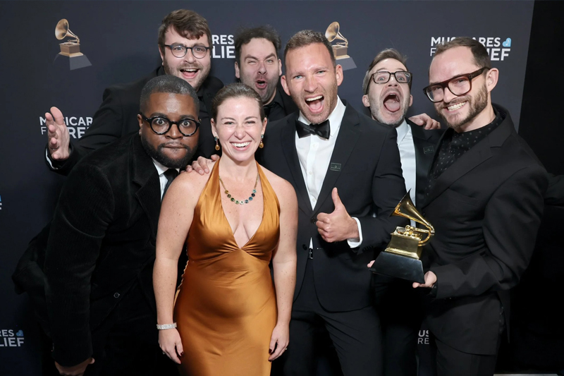 Members of the Akropolis reed quintet posing with their Grammy Award