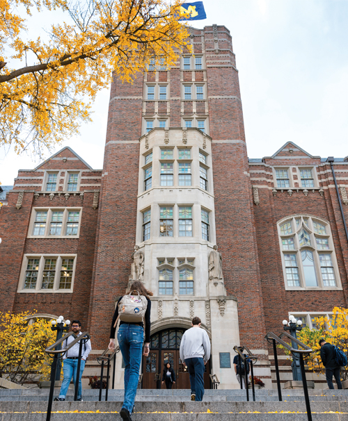 Students walking up the steps in front of the Michigan Union in the fall